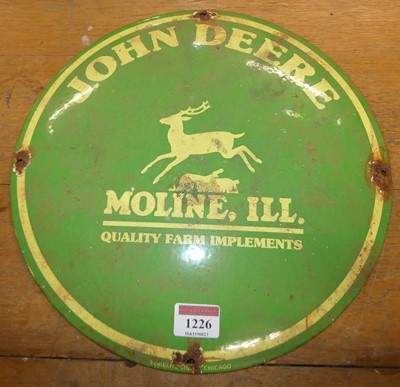 Lot 1226 - A circular convex enamel on metal sign for...