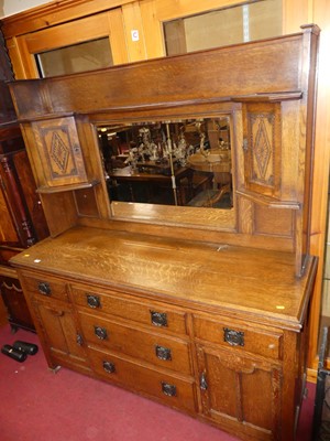 Lot 1228 - An Arts & Crafts oak mirror back sideboard...