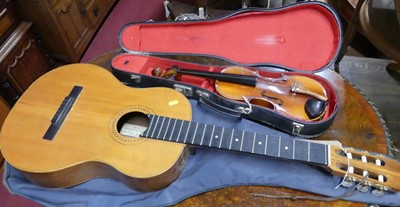 Lot 1231 - A guitar with carrying bag (lacking strings),...