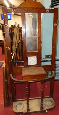 Lot 1235 - A late Victorian walnut mirror back hall stand
