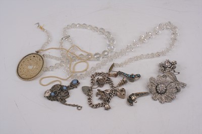 Lot 406 - A silver charm bracelet with eight suspended...
