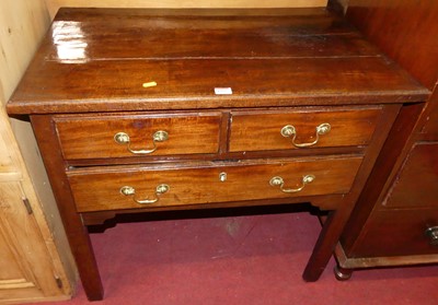 Lot 1255 - A George III mahogany three-drawer low boy,...
