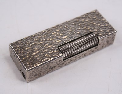Lot 422 - A Dunhill textured white metal pocket...