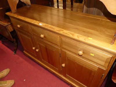 Lot 1268 - A contemporary Ercol pine dresser base having...