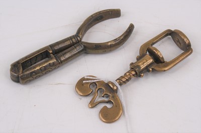 Lot 431 - A 19th century brass thumbscrew/nut cracker,...