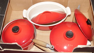 Lot 663 - A collection of Le Creuset red enamel pans and...