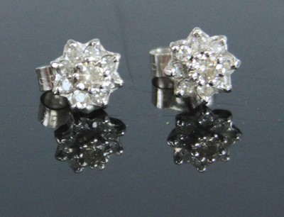 Lot 357 - A pair of 9ct white gold diamond set flower...