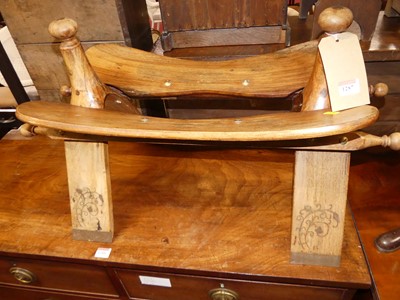 Lot 1287 - A teak camel stool, length 73cm
