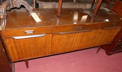 Lot 1294 - A 1960s teak sideboard having three frieze...