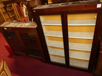 Lot 1305 - A mahogany double door glazed low bookcase,...