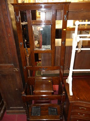 Lot 1317 - An early 20th century oak mirror back...