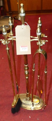 Lot 1329 - Sundry turned brass fire tools on stand (5)