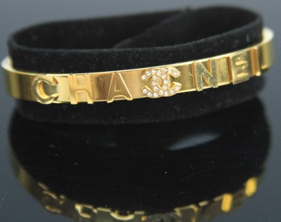 Lot 372 - After Chanel - a gilt metal and paste set...