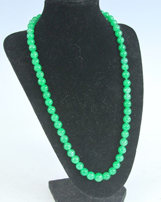 Lot 376 - A modern Chinese beaded and knotted jadeite...