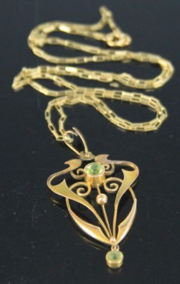 Lot 384 - An Art Nouveau yellow metal and green peridot...