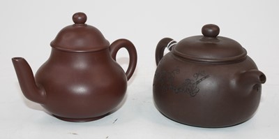 Lot 497 - Two Yixing type red ware teapots, the largest...