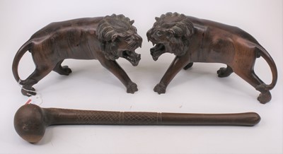 Lot 481 - A pair of carved hardwood models of lions,...