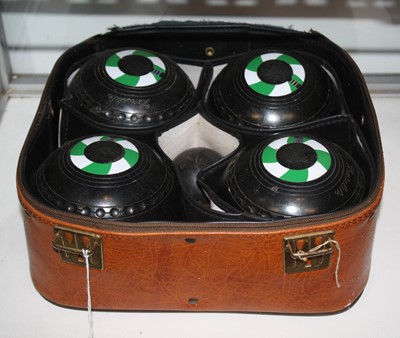 Lot 491 - A set of four boules, in travel case