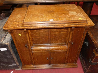 Lot 1333 - An early 20th century oak sewing cabinet,...
