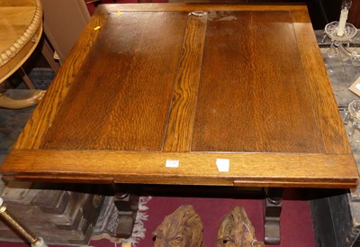 Lot 1338 - A 1930s oak drawleaf dining table, raised on...