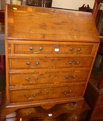 Lot 1417 - A reproduction yew wood slope front writing...