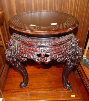 Lot 1423 - A Chinese stained and carved wood circular low...