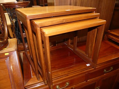Lot 1425 - A 1970s teak nest of three occasional tables,...