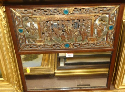Lot 1049 - A Chinese fret carved hard wood wall mirror,...