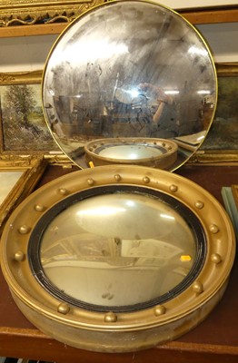 Lot 1054 - A convex wall mirror in a slim gilt mount, dia....