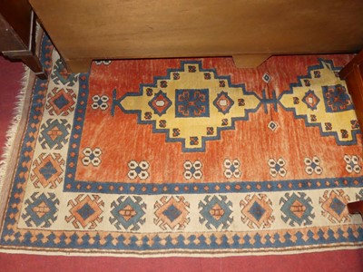 Lot 1195 - A Turkish woollen cream and rust ground rug,...