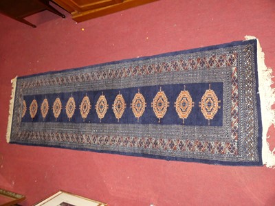 Lot 1197 - A Persian woollen blue ground Bokhara hall...