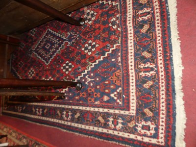 Lot 1198 - A Persian woollen red and blue ground Shiraz...