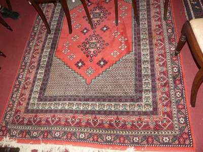 Lot 1199 - A Persian woollen red ground Shiraz rug, the...
