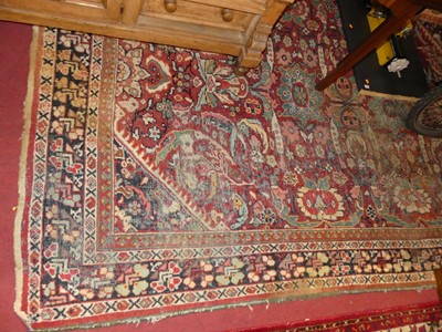Lot 1201 - A Persian woollen red ground Tabriz rug (faded...