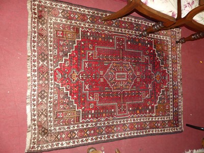 Lot 1203 - A Persian woollen red ground Shiraz rug, 160 x...