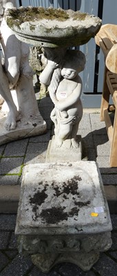 Lot 1526 - A reconstituted stone bird bath, the shallow...