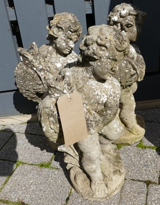 Lot 1528 - A set of three concrete cherub standing...