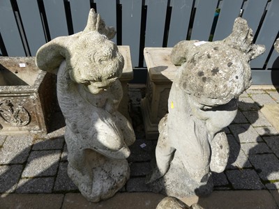 Lot 1541 - A pair of concrete garden statues, modelled as...