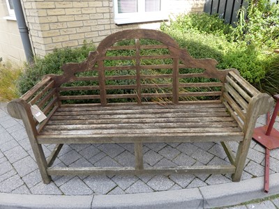 Lot 1549 - A stained and slatted teak three-seater...