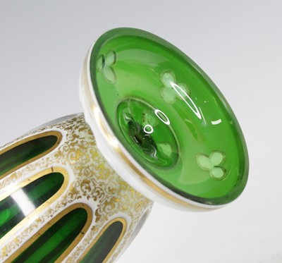 Lot 2055 - A Bohemian green and white overlaid glass vase,...