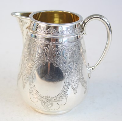 Lot 2092 - A Victorian silver teapot and matching cream,...