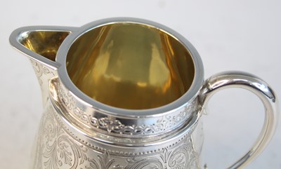 Lot 2092 - A Victorian silver teapot and matching cream,...