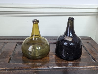 Lot 1062 - A green glass wine bottle, 18th century, of...