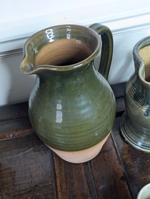 Lot 1017 - A collection of nine green and brown glazed...