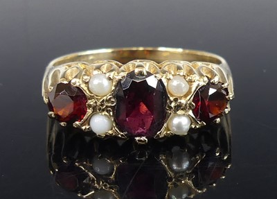 Lot 2829 - A yellow metal, garnet and pearl half-hoop...