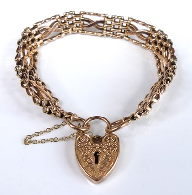 Lot 2797 - A 9ct gold gatelink bracelet, with heart...