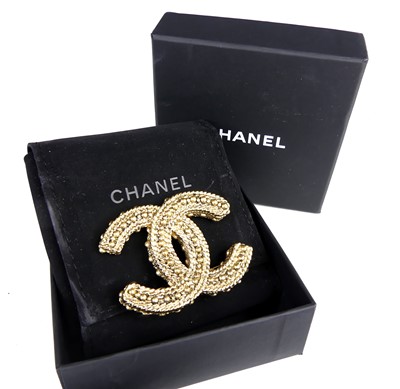 Lot 2817 - A Chanel CC gilt metal and textured brooch,...