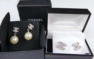 Lot 2818 - A pair of Chanel paste set logo earrings, each...