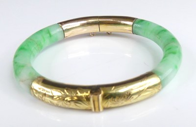 Lot 2869 - An 18ct gold mounted celadon and green jade...