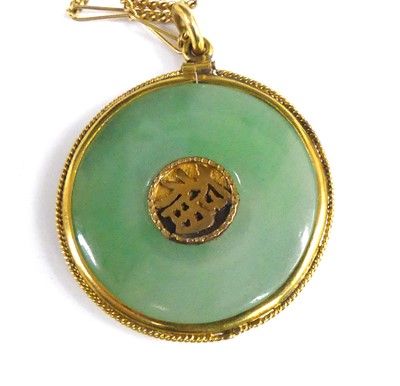 Lot 2870 - A Chinese yellow metal and jade disc pendant,...